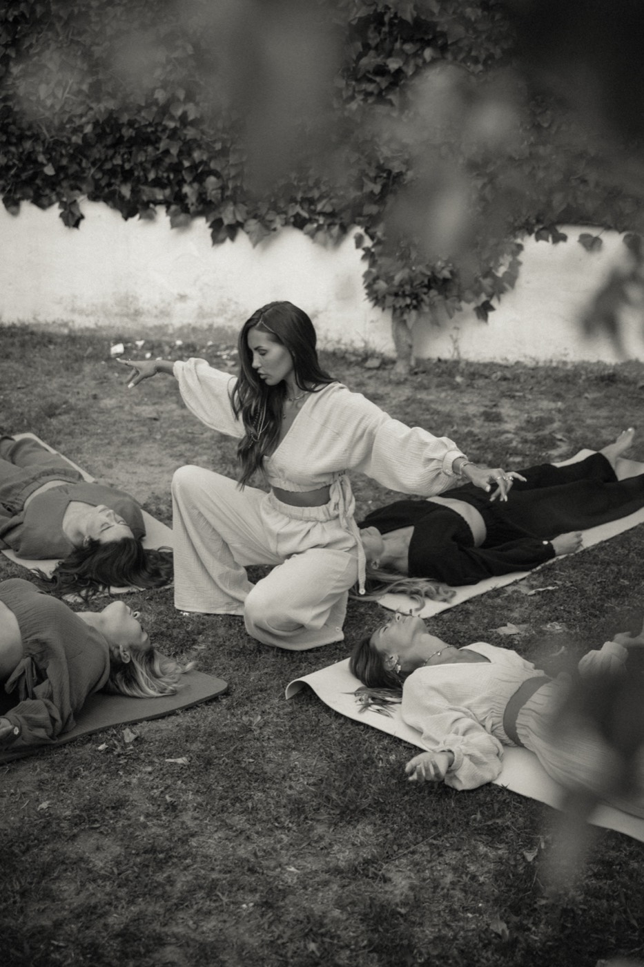 Linnebel kneeling in stillness among women lying in deep process