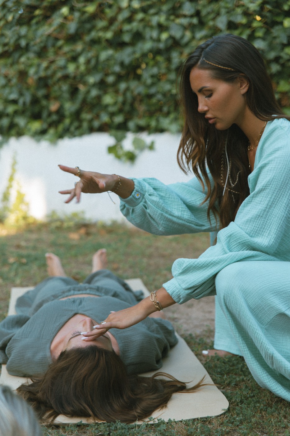 A woman being guided through a deep energetic process, fully held