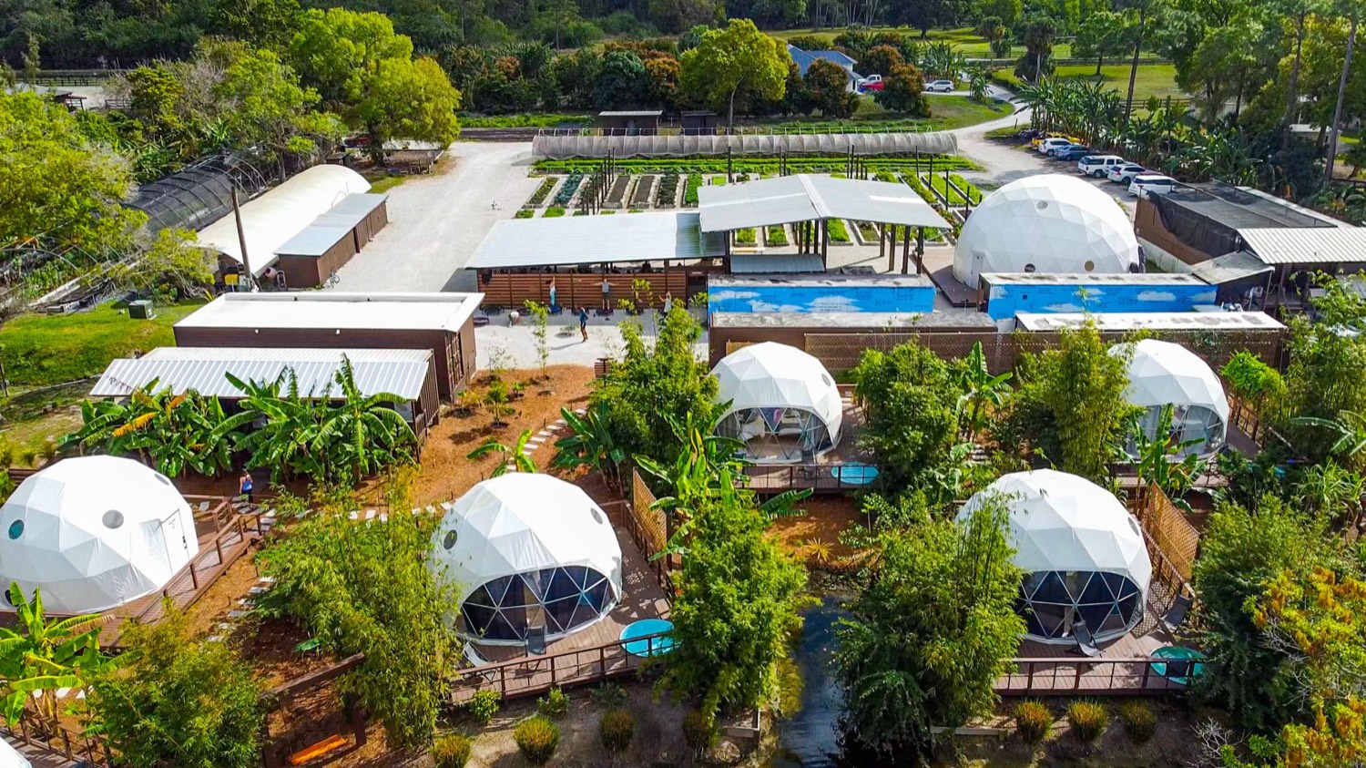 Aerial view of the sanctuary — geodesic dome rooms nestled in tropical gardens